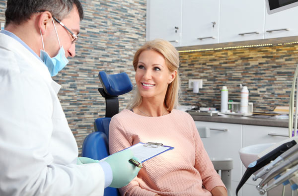Woman talking to dentist during dental exam at Roane Family Dental in West Linn, OR 97068-4310