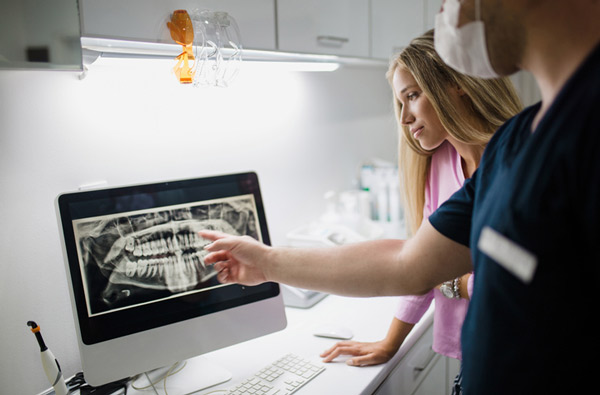 Dentist reviewing a digital xray at Roane Family Dental in West Linn, OR 97068-4310